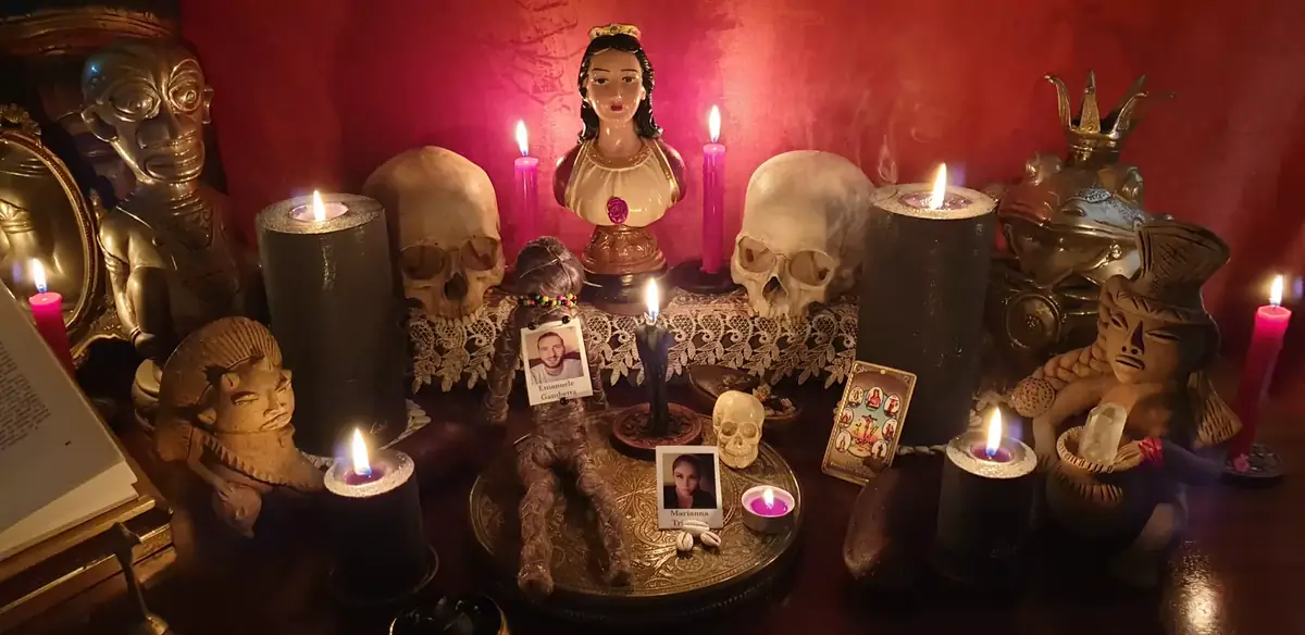Il velluto rosso dell'altare con i crani, il busto votivo e i ritratti